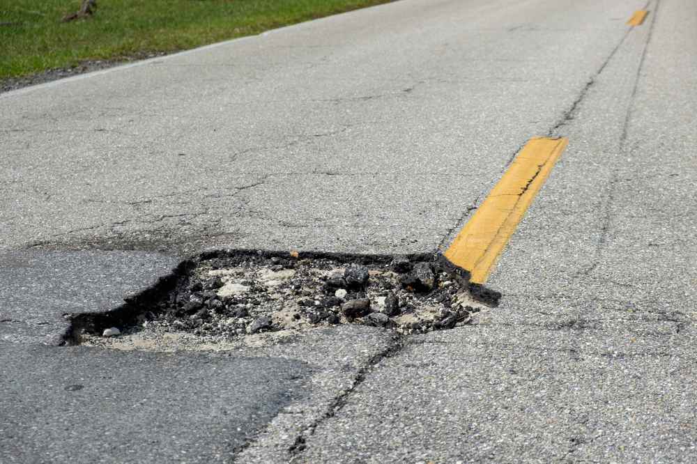 WHAT CAUSES POTHOLES?
